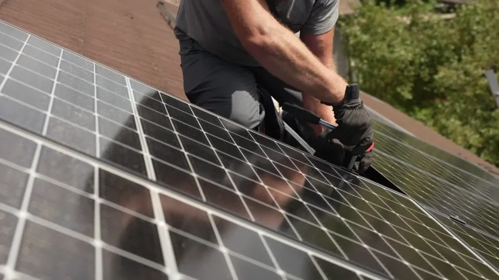 Happy homeowner viewing their solar energy generation on a smart app with a CH Services installer.